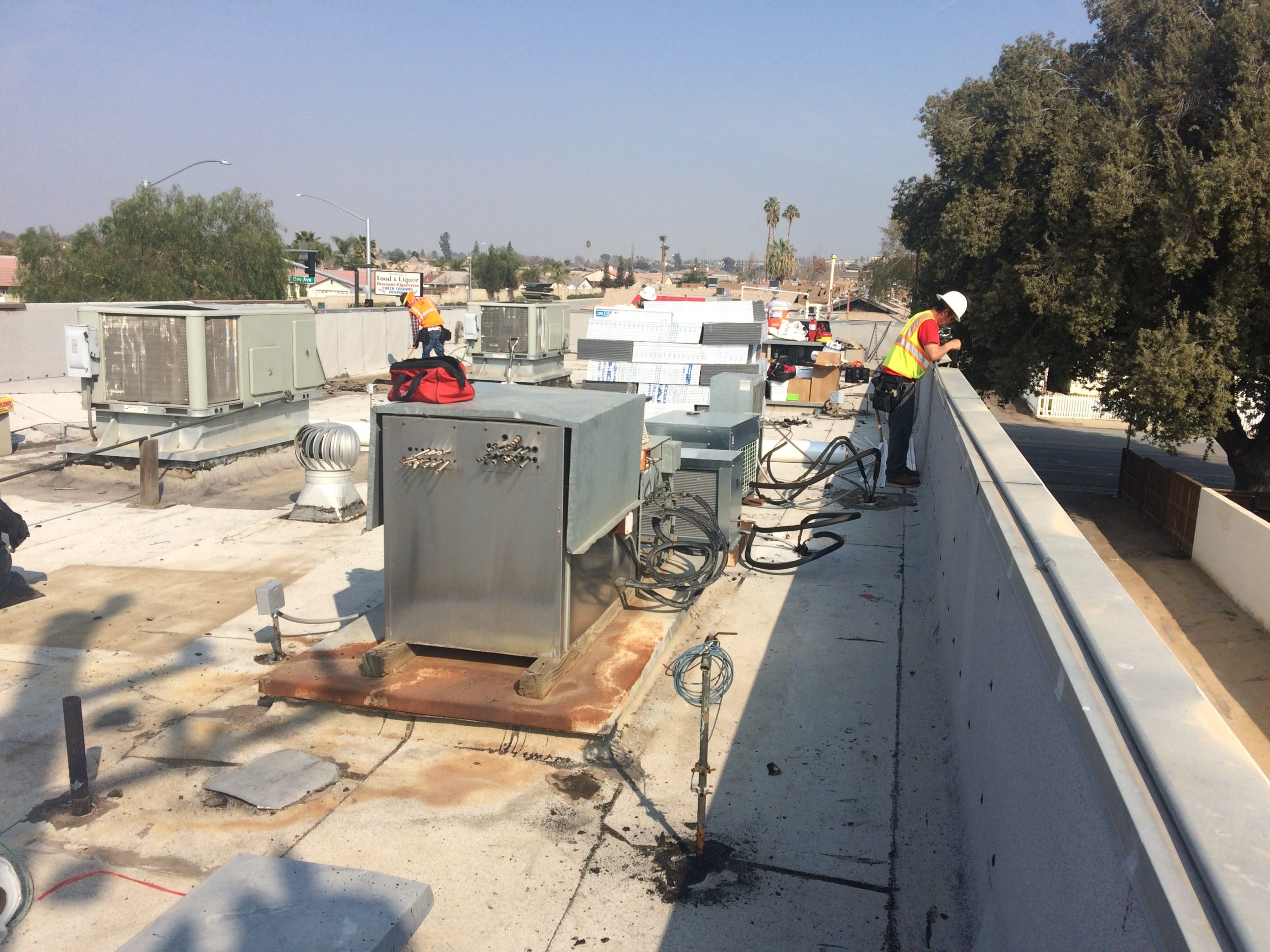 Two Los Angeles roofing contractors working on a roof