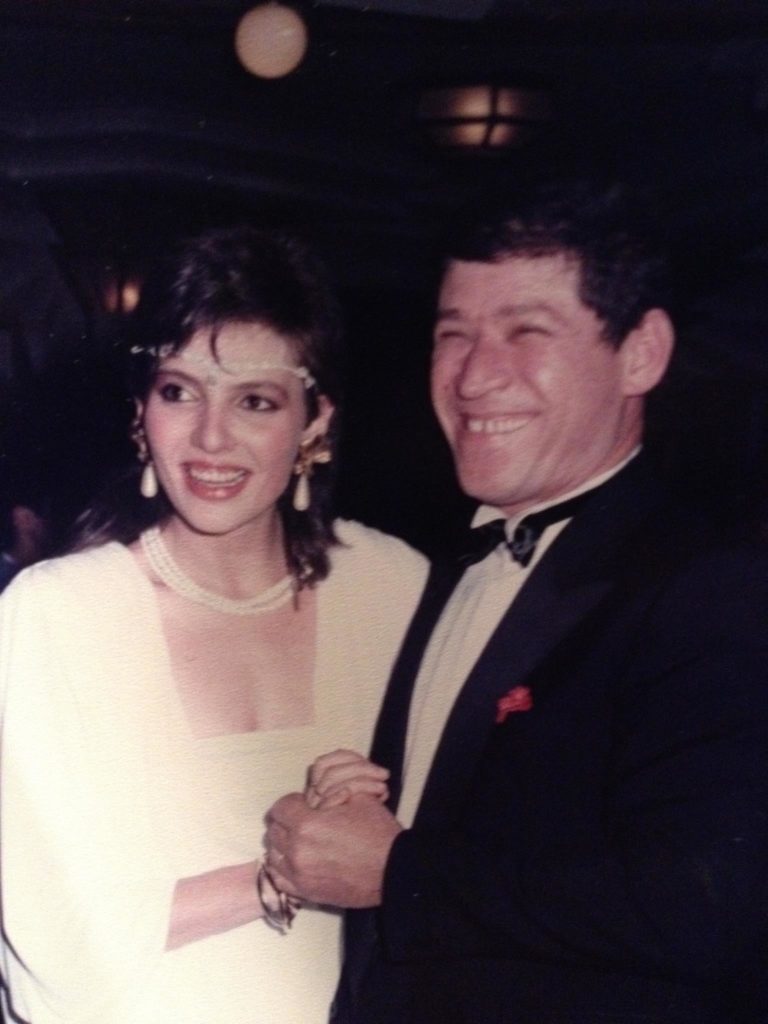 Abe and Inna Tuler holding hands and smiling for a picture at an event