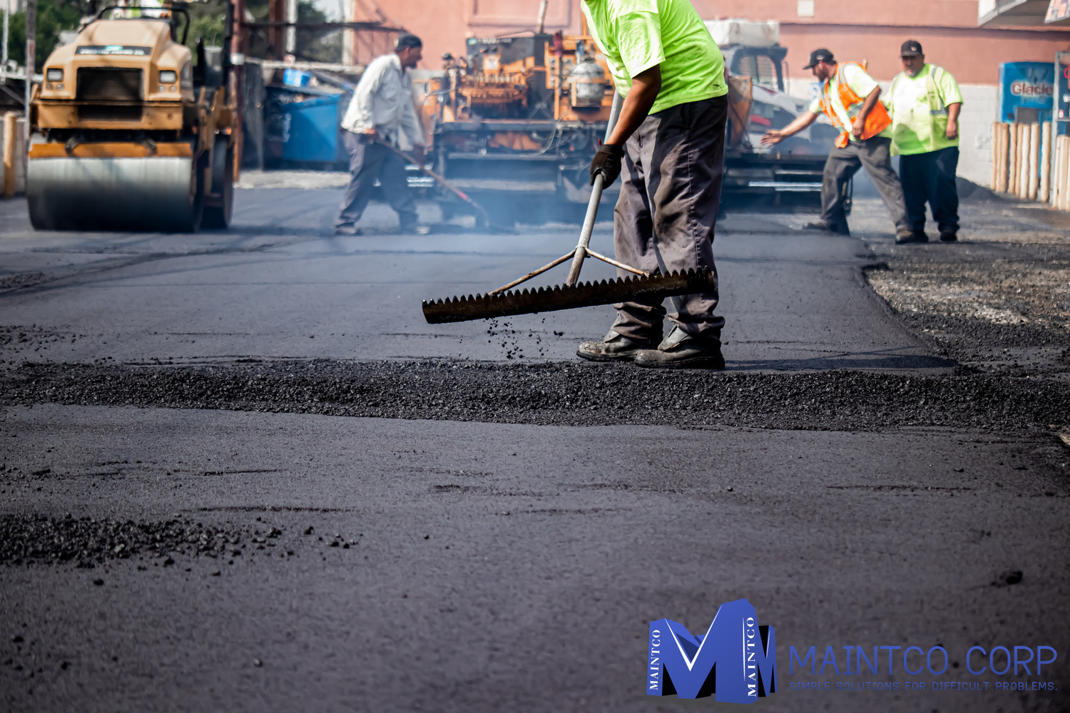 Maintco employees finishing up a parking lot paving project