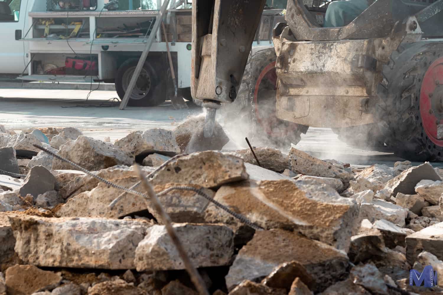 Close up of a skid steer beginning a paving project