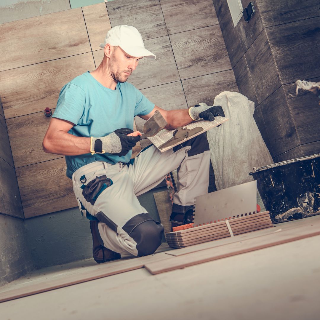 Image showcasing commercial tile installation in progress, with a professional installer laying tiles in a commercial space, ensuring precise alignment and a clean finish.